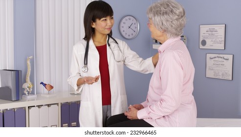 Chinese Doctor Talking To Elderly Patient