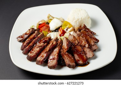 Chinese Duck With Vegetables. Asian Food. Asian Cuisine. Studio Shot On Dark Or Black Background.