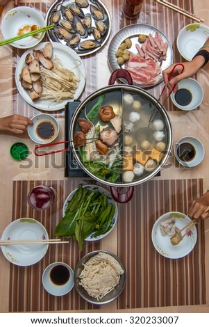 chinese family eating hot pot top view