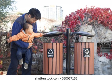 Chinese Father Teaching Son How To Use Garbage Bin, Shot In Beijing, China