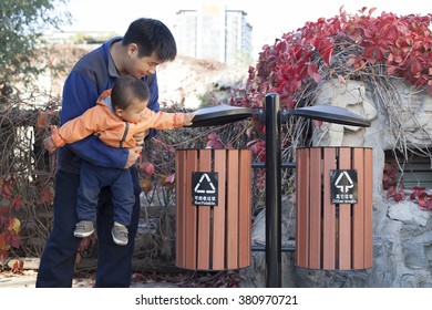 Chinese Father Teaching Son How To Use Garbage Bin, Shot In Beijng, China