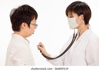 Chinese Female Doctor Checking Patient's Heart With Stethoscope