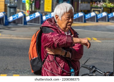 Chinese Female - Manchester , Lancashire-England - 20.09.2022 - Old Chinese Lady Putting On Ruck Sack