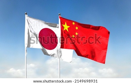Chinese flag and Japanese flag with blue sky. waving blue sky