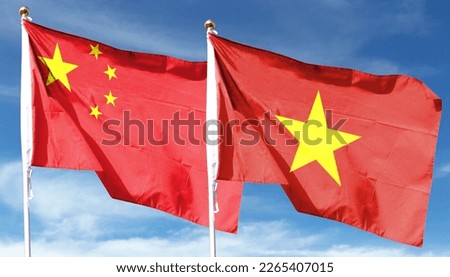 Chinese flag and Vietnam flag on cloudy sky. waving in the sky