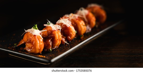 Chinese Food Background Of Prawn Stir Fried With Red Sauce On Black Plate In Dark Background