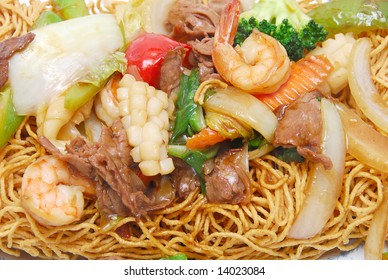 chinese food: closeup of a stir fried beef and seafood with crispy deep fried egg noodle