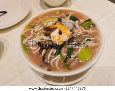Chinese food Fujian Red Mushroom Seafood Lor Mee Noodles at restaurant. Selective focus.