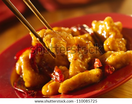 Chinese food - General Tso's chicken with chopsticks.