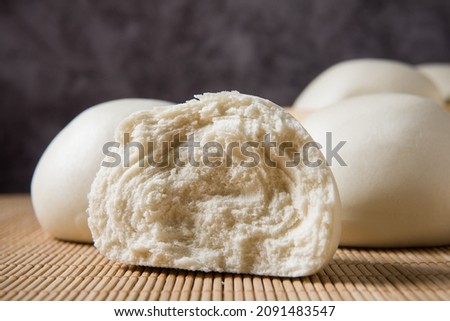 Chinese food half steamed bun close up on table.