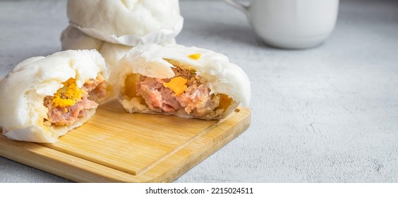 The Chinese  Food Menu Of Steamed Buns Split In The Middle Reveals Pork Belly On White Table