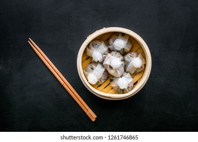 Chinese Food Set With Dim Sum, Sticks On Black Background Top View