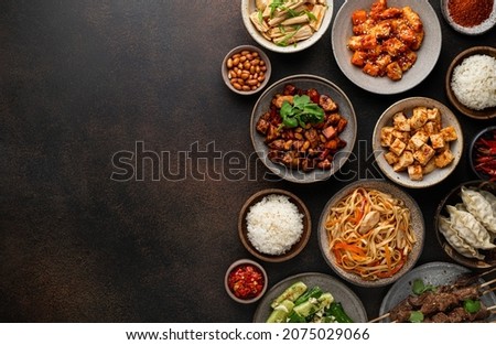 chinese food, chinese traditional cuisine dishes on dark background, top view, copy space
