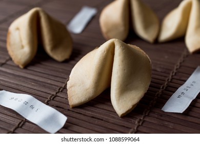 Chinese Fortune Cookies on Bamboo Mat with Chopsticks and Paper - Shutterstock ID 1088599064