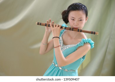 Chinese Girl Blowing Bamboo Flute