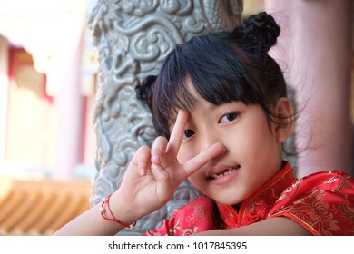 Chinese girl in a bright smile. Mark of Victory
