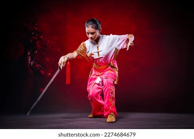Chinese girl holding sword with Chinese martial arts concept.