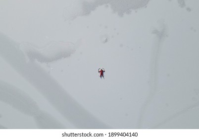 Chinese Girl Making Snow Angel, Top View.