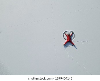 Chinese Girl Making Snow Angel, Top View.