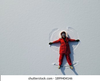 Chinese Girl Making Snow Angel, Top View.