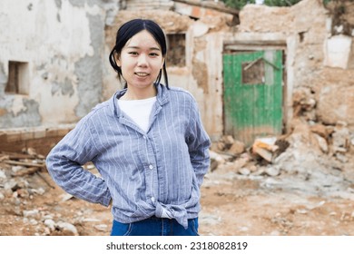 Chinese girl near damaged building after earthquake
