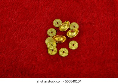 Chinese gold coin over the red soft fabric