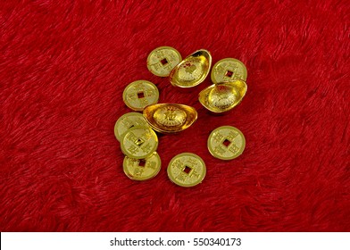 Chinese gold coin over the red soft fabric