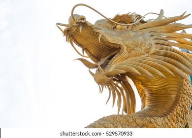 Chinese Golden Dragon Statue In The Background Of Blue Sky