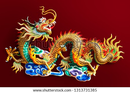 Chinese golden dragon statue for decoration in the public temple isolated on red background with clipping path