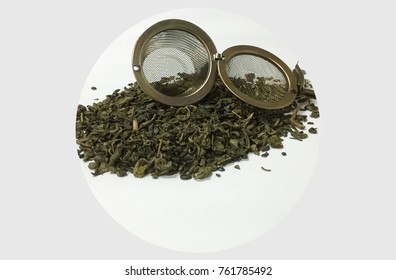 Chinese Green Gunpowder Tea Leaves And A Tea Strainer.