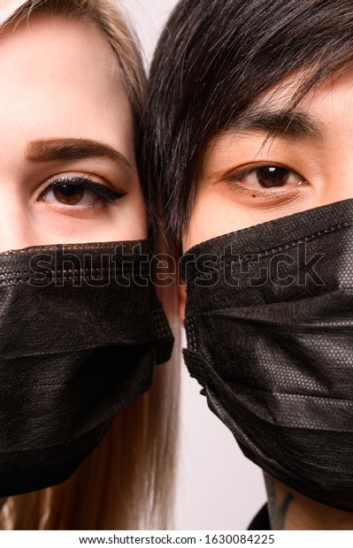 Chinese infection Corona Virus masked girl and\
asian man on the white background, the concept of the epidemic of\
the virus in China
