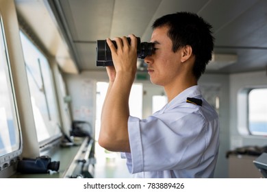 Chinese Junior Navigation Officer Navigating His Ship