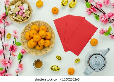 Chinese Language Mean Rich Or Wealthy And Happy.Top View Decoration Chinese New Year & Lunar New Year Holiday Background Concept.Flat Lay Orange With Pink Flower On White Wooden At Home Office Desk.