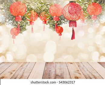 Chinese Lantern On Tree And Wooden Table Over Golden Bokeh For Chinese New Year Background.