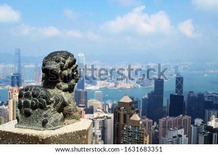 Chinese lion culpture on the Hong Kong view background
