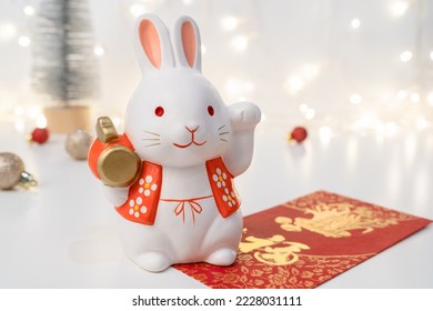 Chinese Lunar New Year concept. Greeting for Chinese Rabbit New Year with red envelope. The Chinese word means happiness or good fortune. 