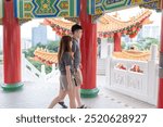 Chinese Malaysian couple in their 30s spending time at famous Chinese temple popular with tourists in Kuala Lumpur, Malaysia.