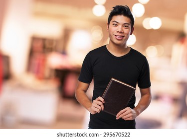 Chinese Man Holding A Book