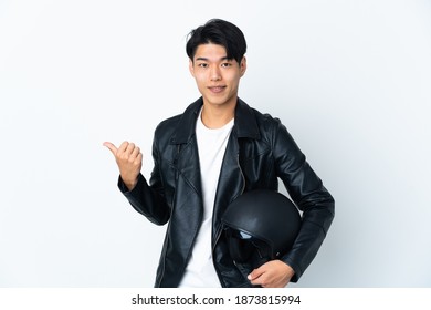 Chinese Man With A Motorcycle Helmet Isolated On White Background Pointing To The Side To Present A Product