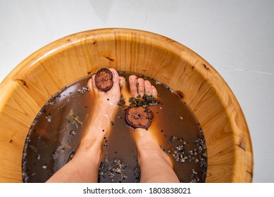 Chinese Medicine Foot Bath And Foot Therapy, A Woman Is Bathing Her Feet