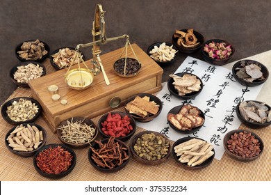Chinese medicine ingredients with scales and calligraphy.  Translation reads as chinese herbal medicine as increasing the bodys ability to maintain body and spirit health and balance energy.