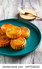 Chinese Moon Cake  In Green Plate On Grey Wooden Table