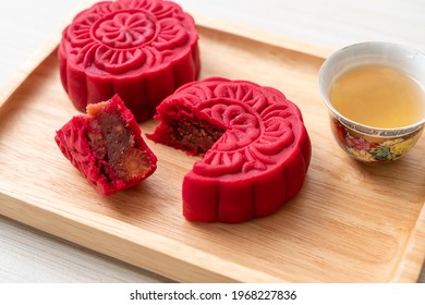 Chinese moon cake strawberry red bean flavour on wood plate