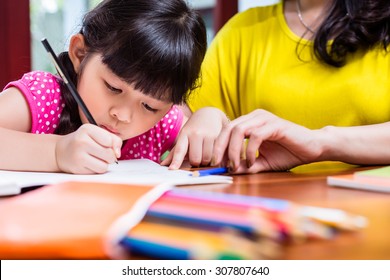 Chinese Mother Homeschooling Her Child Teaching Her Daughter To Write