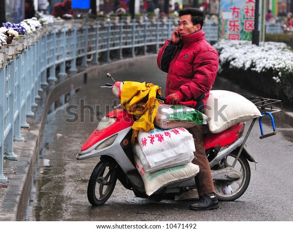 Chinese motorcyclist in\
shanghai street