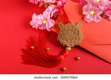 Chinese New Year 2022 decoration Gold Tiger, Red Envelope on red background. Flowers of good fortune.