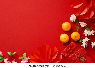 Chinese New Year 2023 festival decorations, mandarins, flowers, envelopes on red background. Flat lay, top view. - Shutterstock ID 2222067759