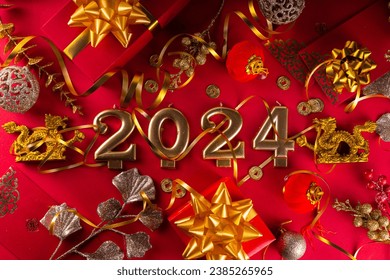 Chinese New Year 2024 greeting card. Bright red asian year of the dragon background with golden dragon figurine, Chinese lanterns, traditional jewelry, gifts, coins, cookies with wishes, copy space - Powered by Shutterstock