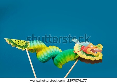 Chinese new year background with green paper dragon.