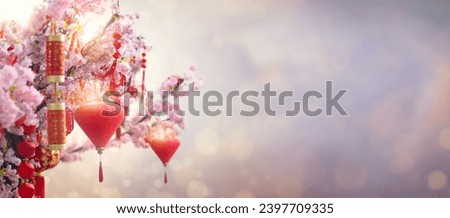Chinese new year celebration in Asia. Pink, red and golden lantern on Japanese sakura tree for Lunar new year party. Background with glitter and bokeh lights. Cherry tree blossom. 
